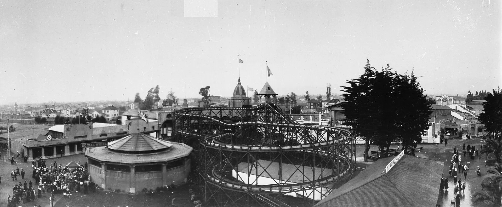 Black-and-white panorama over Idora Park’s roller coaster, carousel building, and crowds