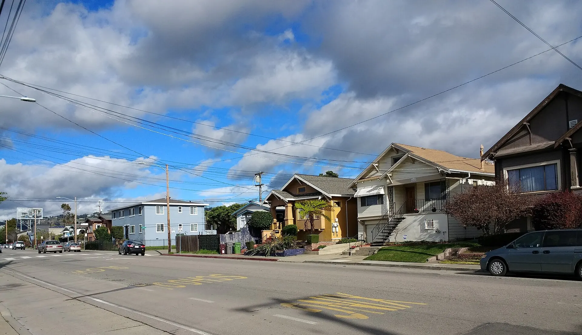 A row of early-1900s houses on a North Oakland street