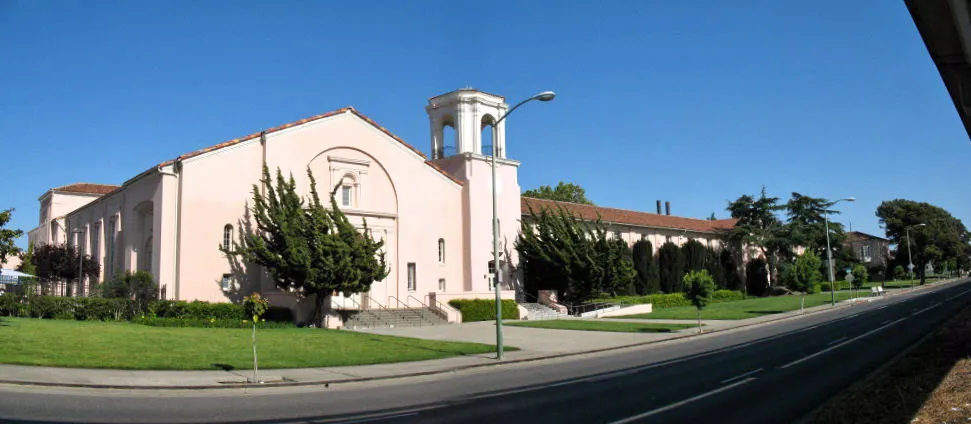 The pink Spanish-revival former University High School building with its bell tower